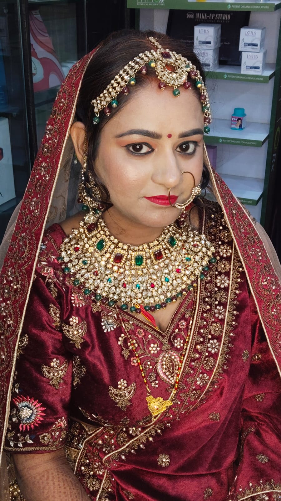 Maroon bridal portrait with rose at Looks and Locks
